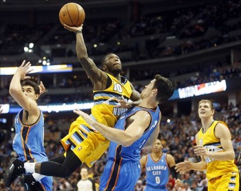 Former Thunder bench player Nate Robinson attempts to drop the lay-in over Nick Collison. Robinson was the only bench scorer on either team to manage double digits, finishing with 12.