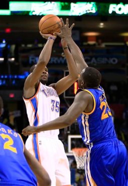 Kevin Durant shoots over Draymond Green. Durant's 54 points establishes a new career-high, while Green contributed 10 from the Warriors bench.